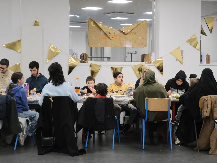 people eating food at a long table